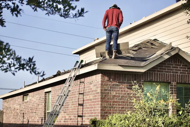 Professional roofer working on a residential roof in Potsdam